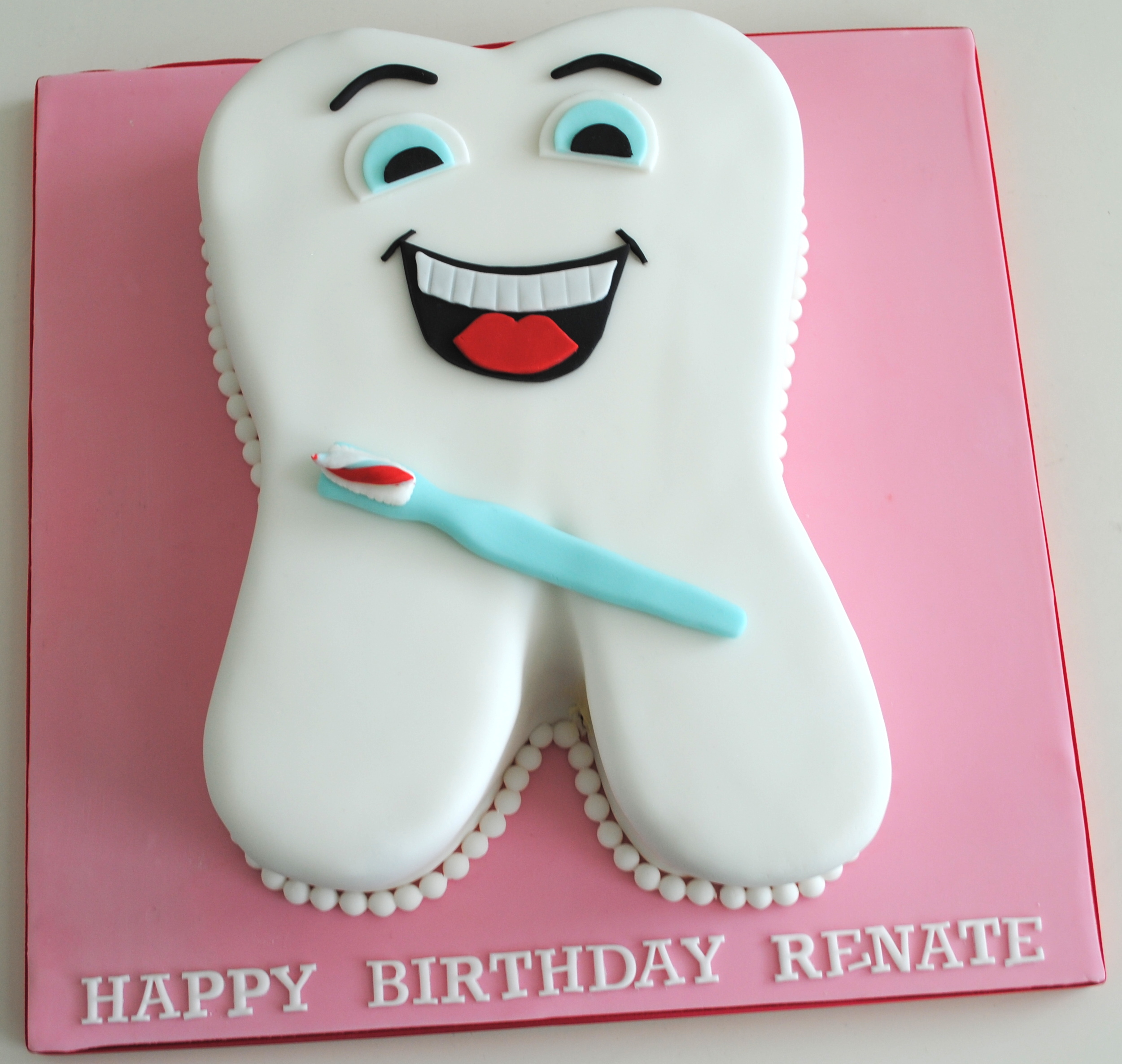 Comical tooth birthday novelty cake