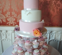 Chic pink and white 3 tier wedding cake and cupcakes