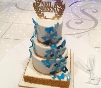 Blue and gold butterfly 4 tiered wedding cake