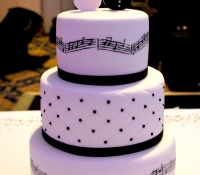 Bride and groom guitar music script wedding cake